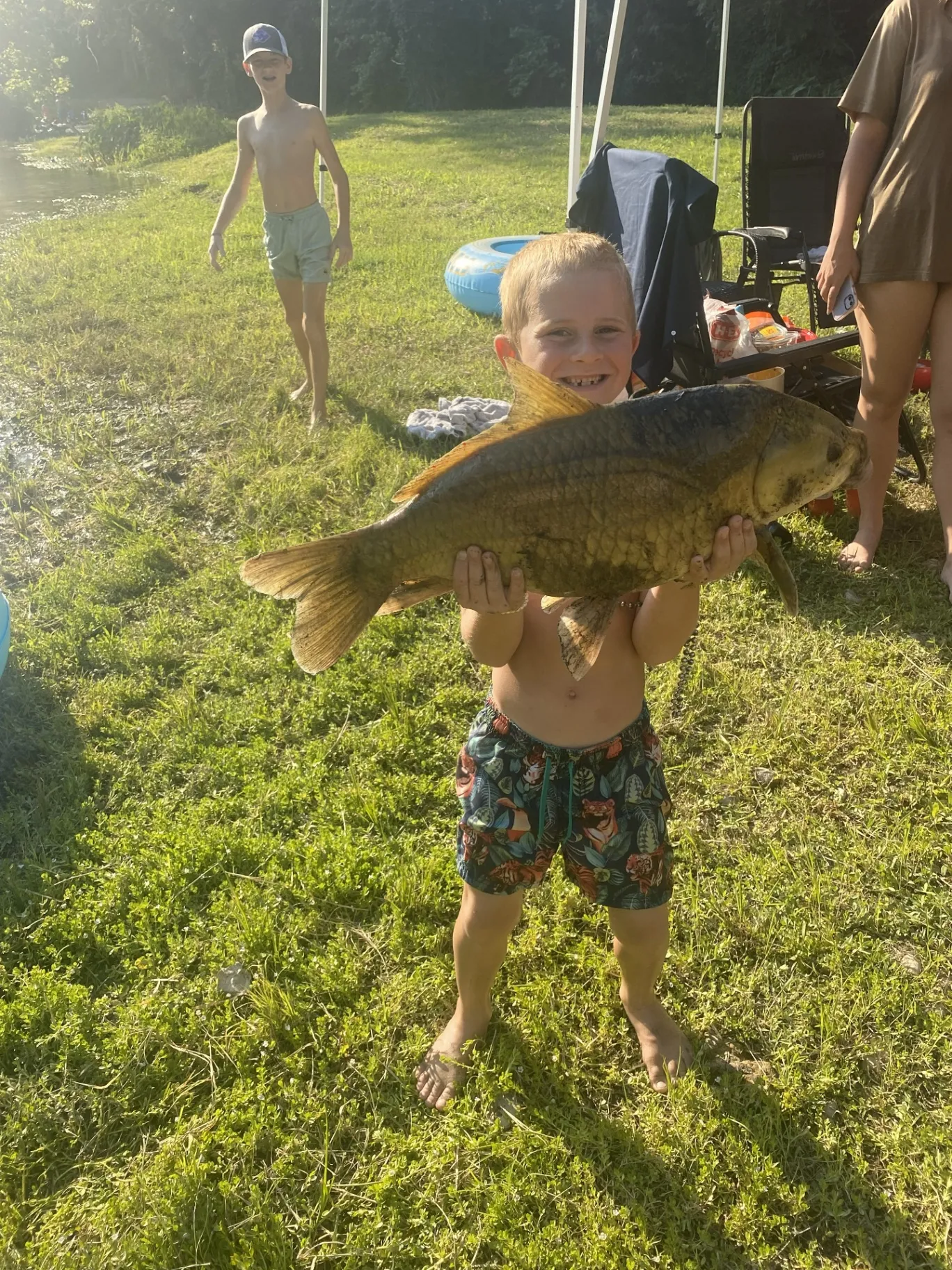 Boy showing off his big fish catch